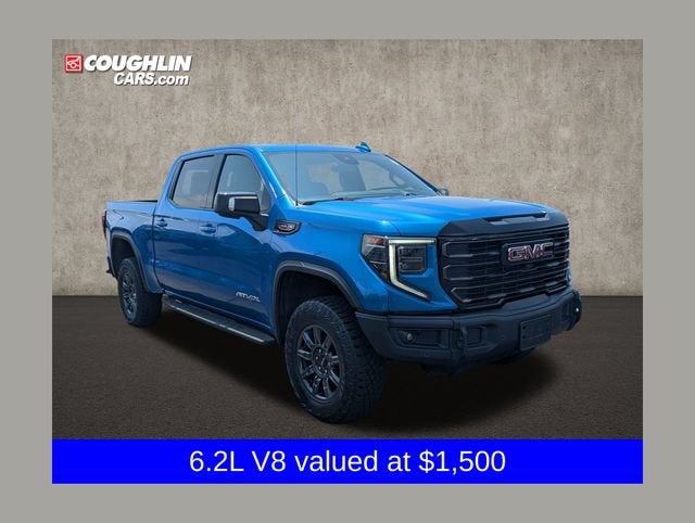 2024 GMC Sierra 1500 AT4X in Dynamic Blue Metallic — front three-quarter view